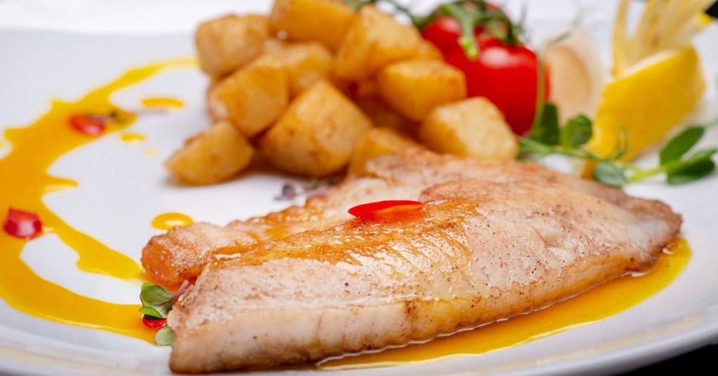 Potatoes fish filet and veggies dish