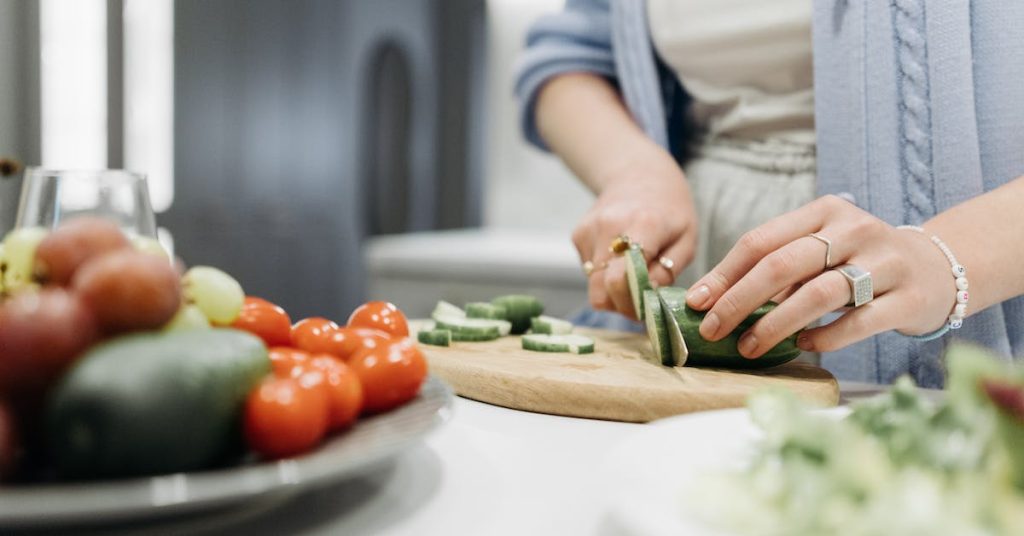 person-slicing-cucumber for chilled avocado soup