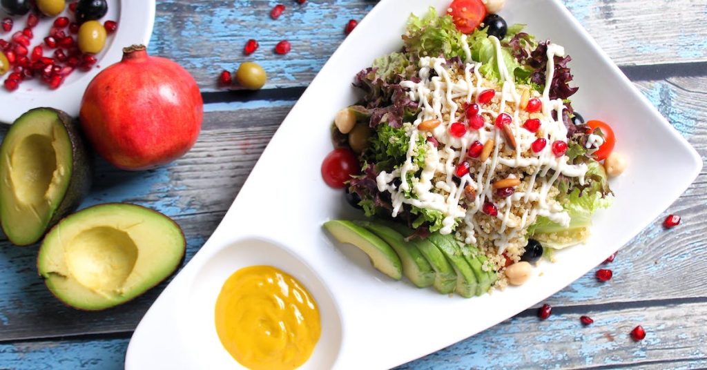 quinoa with avocado slices on ceramic plate