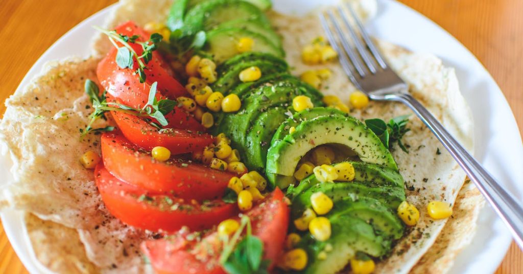 Healthy sliced-tomato-and-avocado-on-white-plate