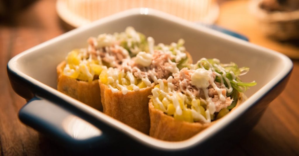 three-tacos-on-black-and-white-ceramic-bowl